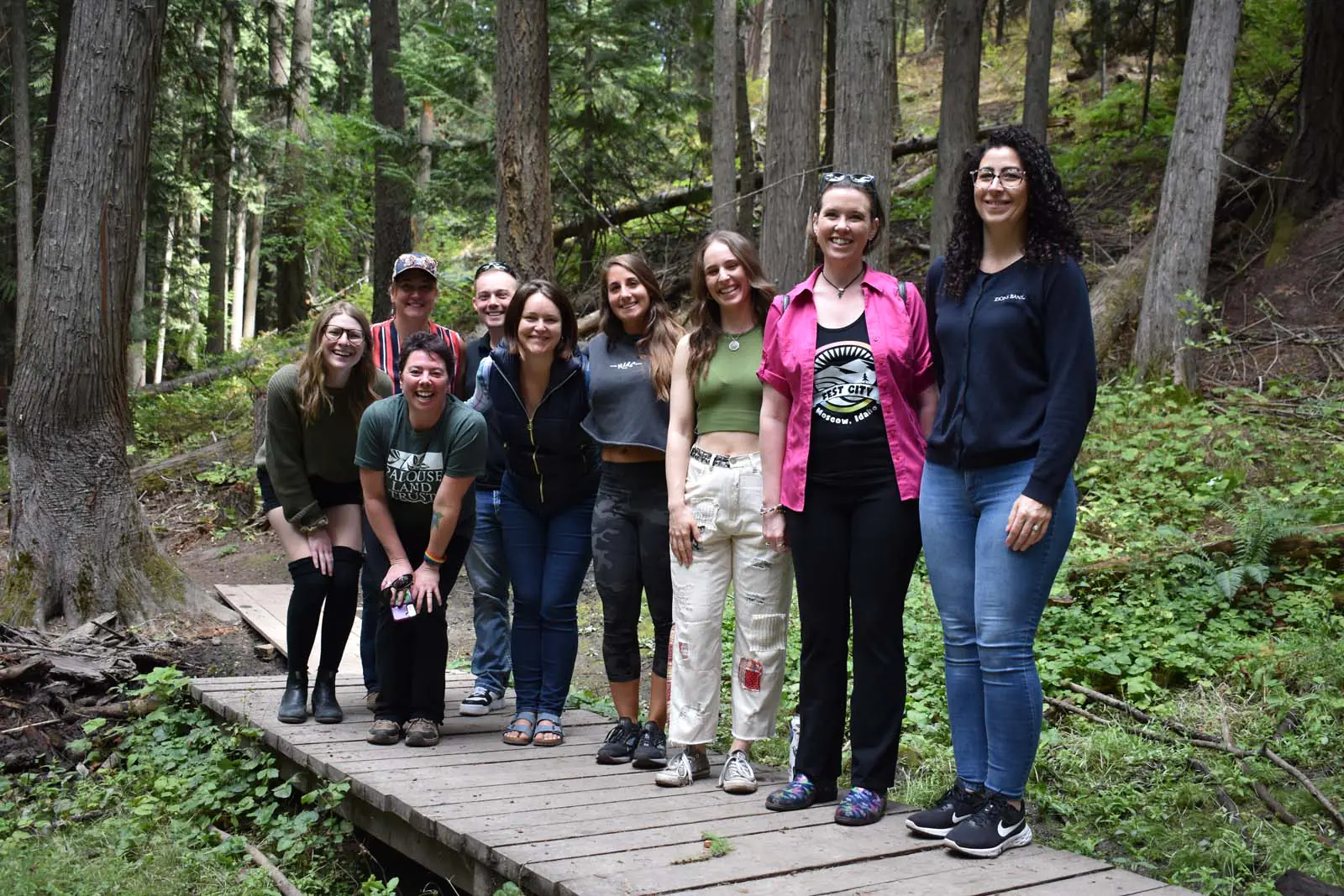 Ambassadors Group of Ambassadors for the Moscow Chamber standing on a small bridge in a forest