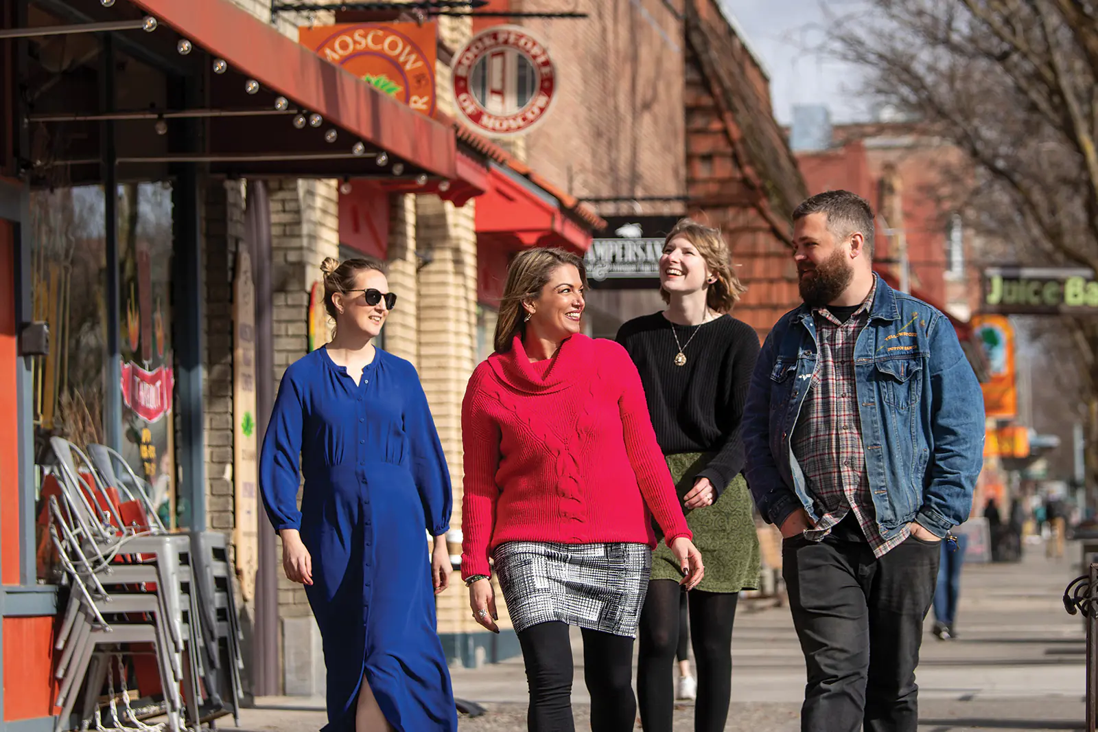 Tourism + Marketing Group of people walking on shop lined sidewalk in Moscow, Idaho