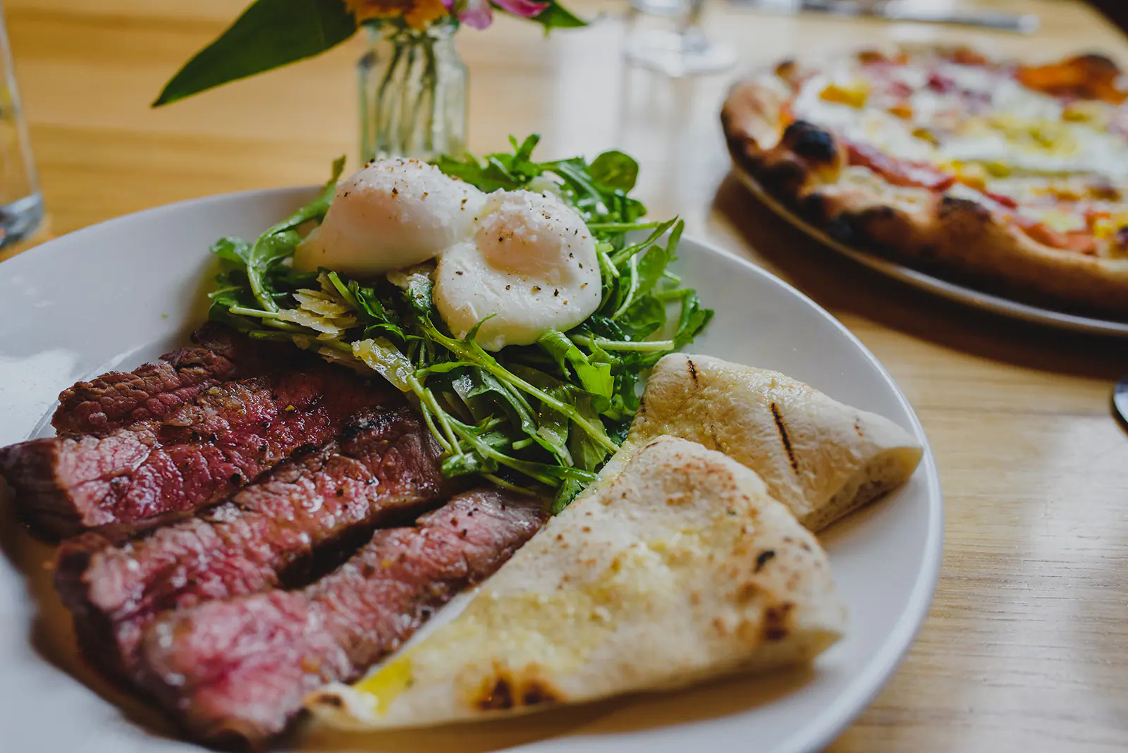 Restaurants Close up of plate of steak, eggs, greens and pita bread at many of the restaurants in Moscow Idaho